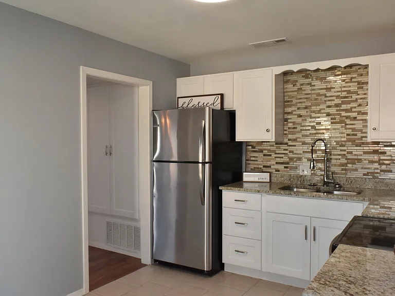 Kitchen leading to bathroom
