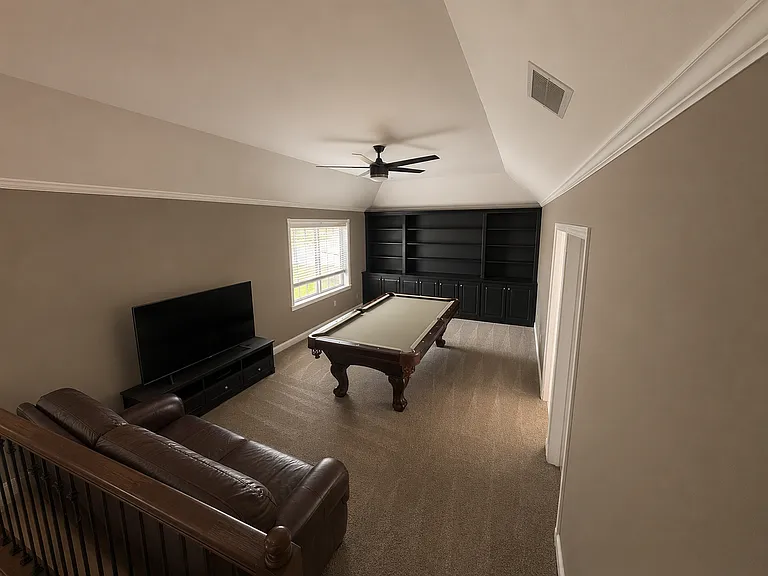 Upstairs game room with pool table, TV and seating