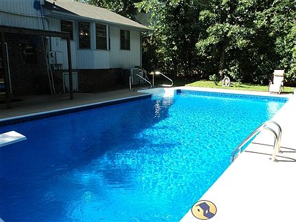 view of pool and back of house
