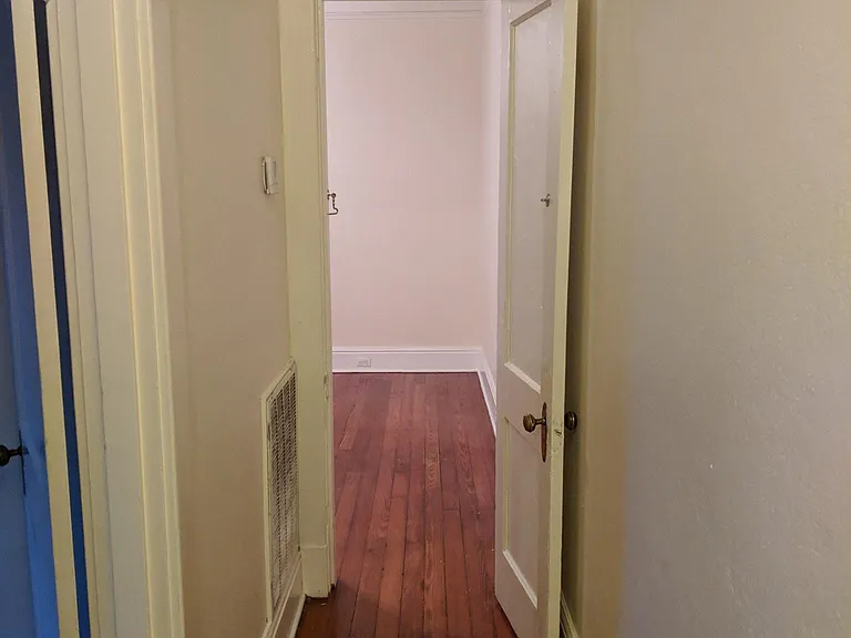 Hallway. The bedrooms open off this hallway. The open door is to the back bedroom.