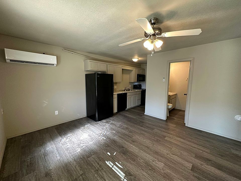 Living/kitchen area with vinyl wood floors and fresh paint