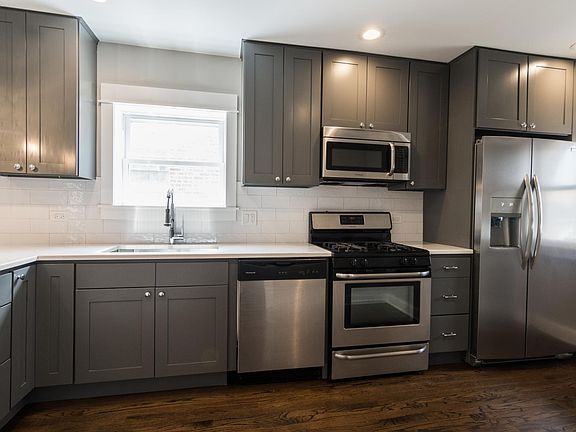 Kitchen with stainless steel appliances and quartz countertop