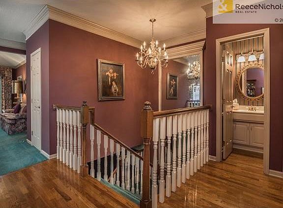 Two-story open staircase has a built in mirror.