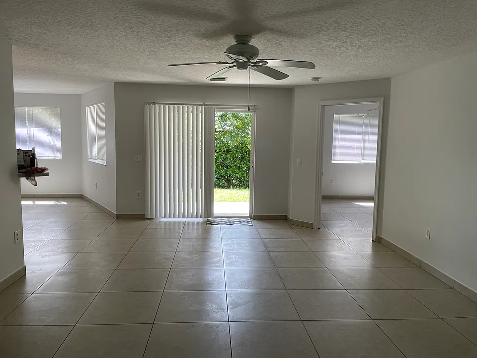 Main living area with sliding door to patio and backyard