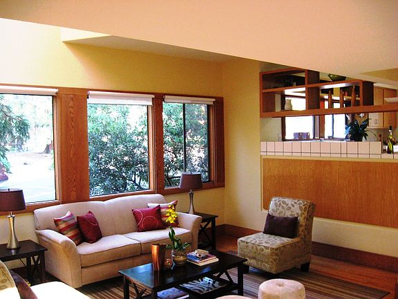 Spacious living room open to the kitchen and looking out at the park 