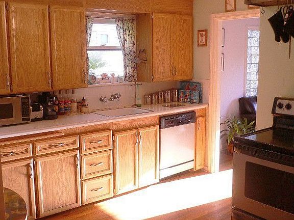 The spacious kitchen has stainless appliances. The stainless fridge is to the left. This photo is ta