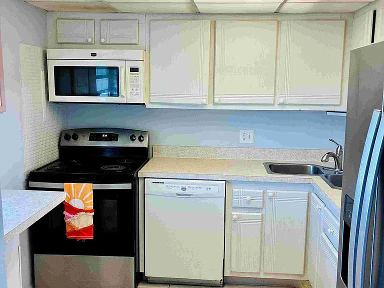 Kitchen pass through to Dining to left of Refrigerator