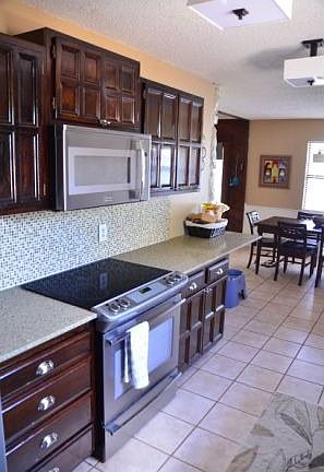 Quartz countertops, glass tile backsplash, Frigidaire Professional appliances