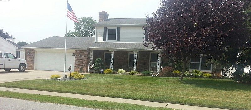 roomy porch & beautifully landscaped yard