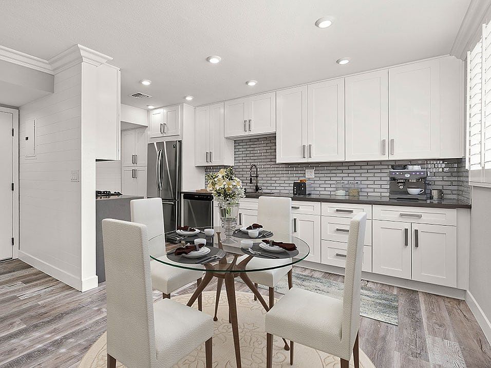 Hardwood floored dining room with view of gorgeous tiled kitchen.