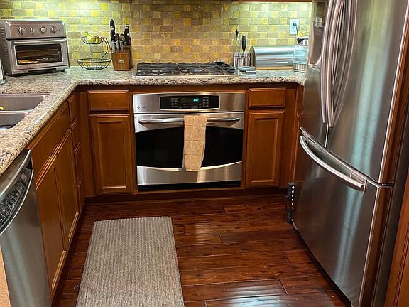 Kitchen with updated appliances and granite counters. Pantry not seen in picture. Removable appliances (i.e. toaster, bread storage, knives) not included in lease