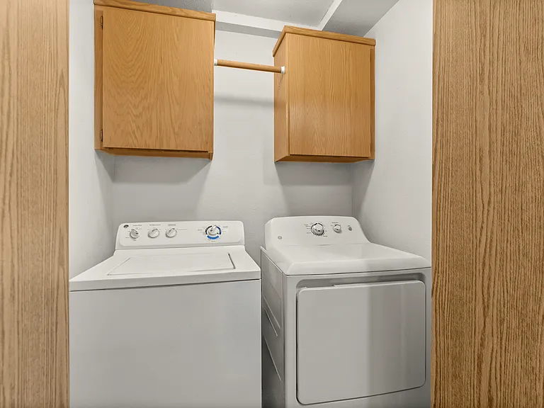 Convenient in-unit laundry with full-size washer and dryer and overhead storage cabinets. Convenient in-unit laundry with full-size washer and dryer and overhead storage cabinets.