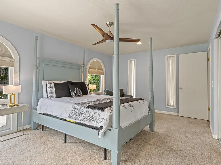 Primary bed with queen sized bed and walk in closet and private bath