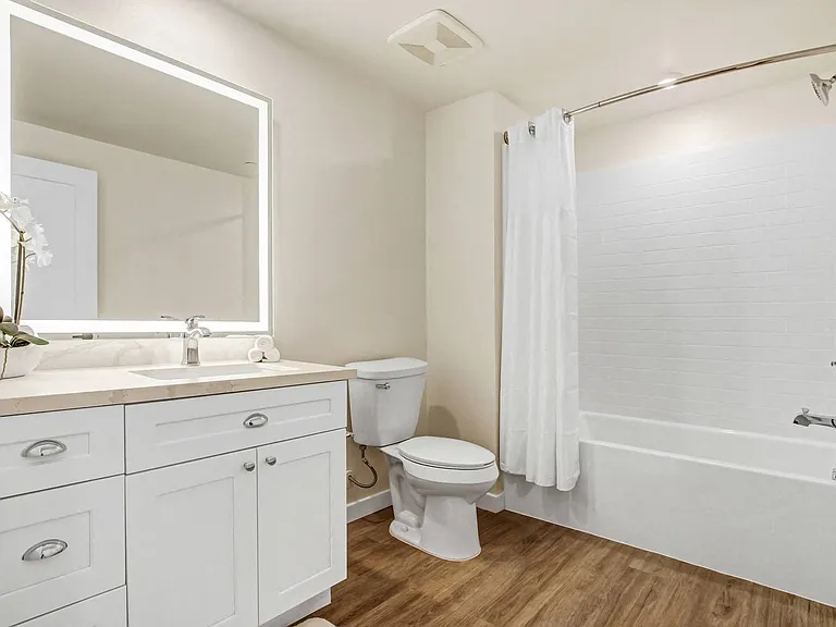 Bathroom with backlit LED vanity mirrors