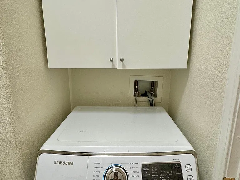 Samsung Front Load Washer with 2 cabinets in laundry room for extra storage