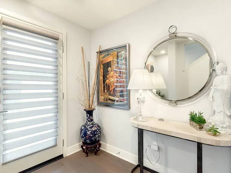 This is the home's entrance, located on the center level. Crystal lamp, closet, and a "Children of the World" introduction art piece prefaces and welcomes you as you enter.