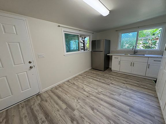 Living room with kitchenette. New cabinets with quartz countertops.