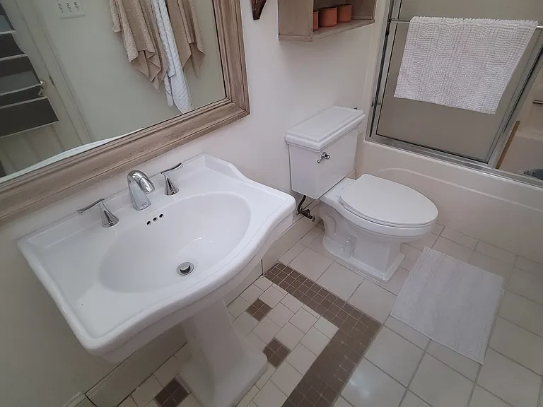 ceramic tiled bath with south facing window for natural light.