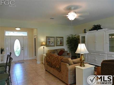 Great room floor plan with tile in all living areas.  Welcoming entry featuring window sidelights and tile listello.