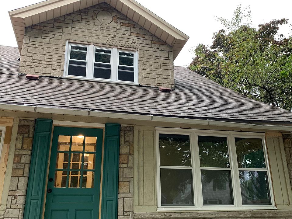 View of front of house. Upper windows are the unit's living room windows.