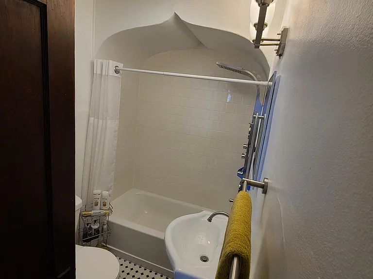 New Bathroom featuring Custom Tile Shower Walls and Flooring with brand new toilet, vanity, medicine cabinet, towel bars, and lighting