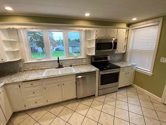 Renovated Kitchen with Sunset view, casement windows, LG appliances, New Countertop and Backsplash, Garbage disposer & Counter Recessed Lights. New Kohler Sink & Moen Faucet.