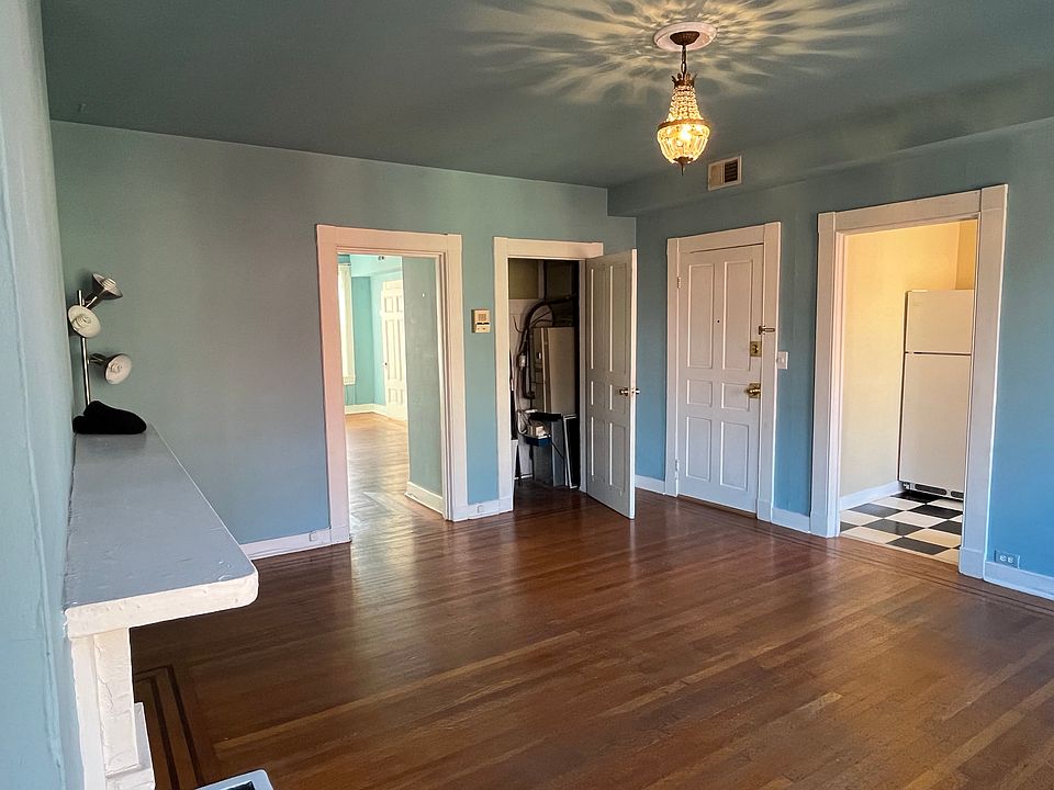 Living room with main entrance, closet, and entrance to kitchen