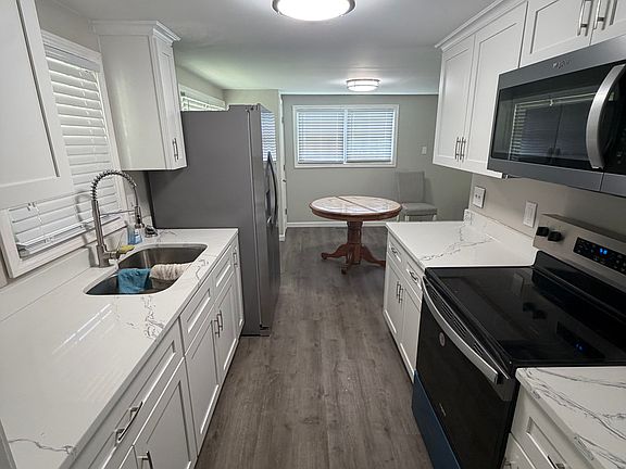 new galley kitchen with new cabinets and appliances