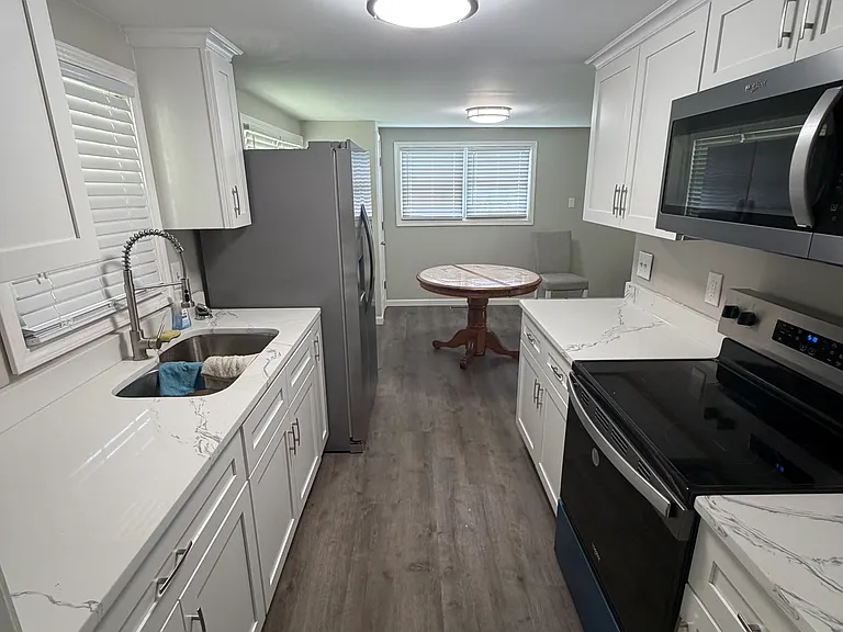 new galley kitchen with new cabinets and appliances
