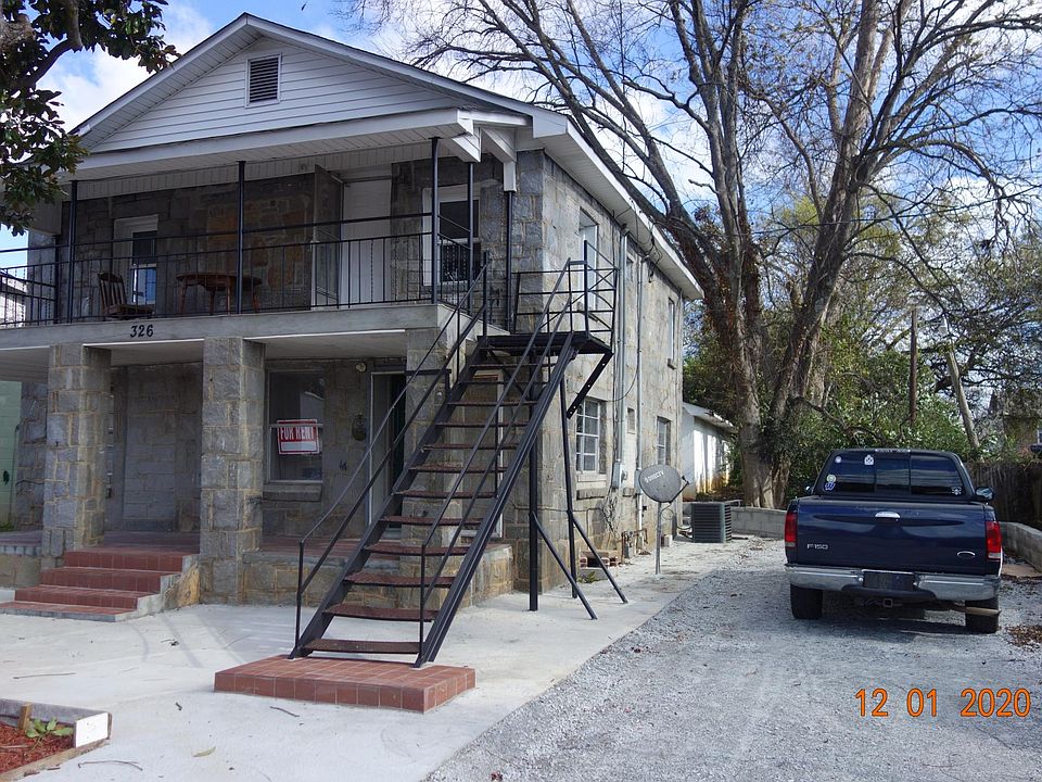 Magnolia tree in the front and parking on east side of building