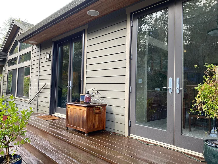 Double oversized 8' tall French doors lead to expansive deck from living and dining room.