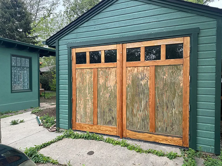 Front of garage with distressed wood barn doors