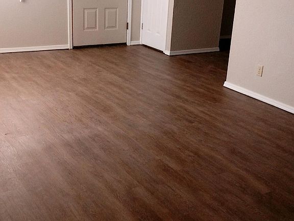Living area, showing front entrance and vinyl flooring