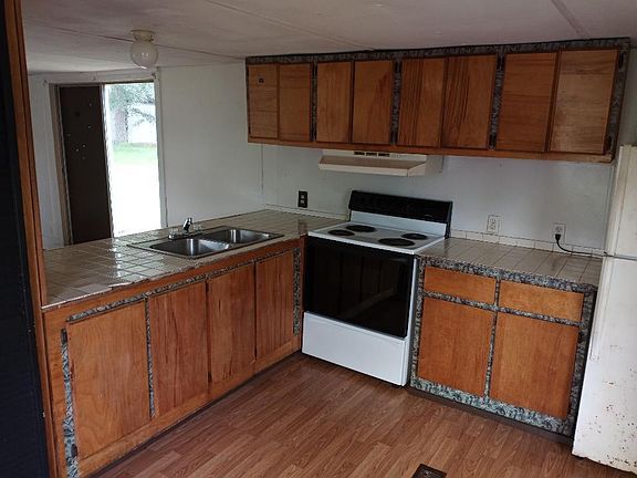 Kitchen with double sink open to living room