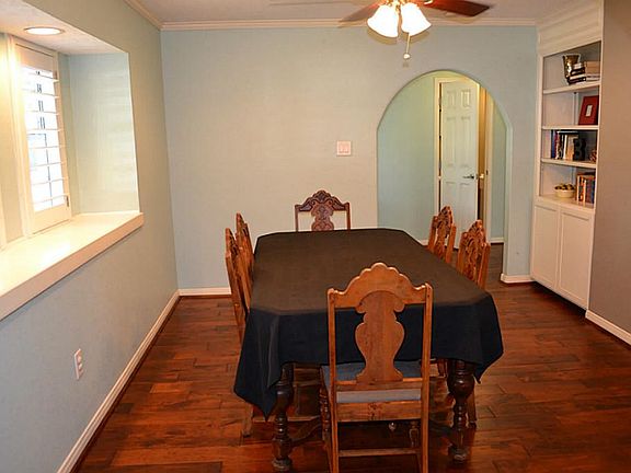 The formal dining has built in storage and windows with plantation shutters.