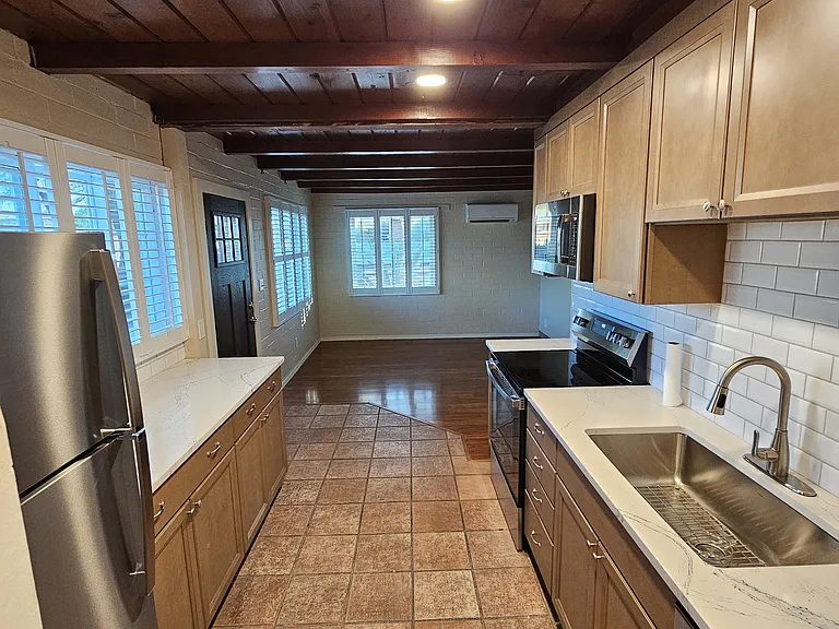 Completely renovated kitchen with stainless steel appliances and large dining/living space