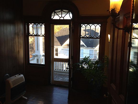 Living area leading to the balcony. Note the original ornat