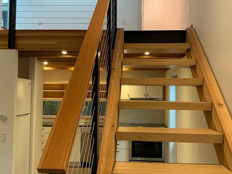 Open stairs up to lofted bedroom.