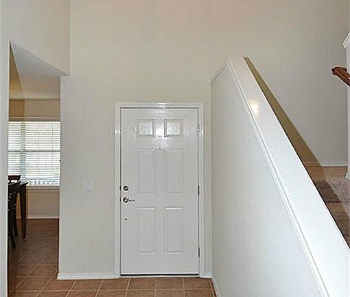 Dramatic two story foyer entry. Windows above the front door add additional lighting to this open fl