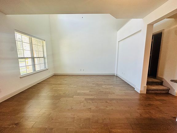 Living room featuring 20-foot ceiling, wood-type flooring