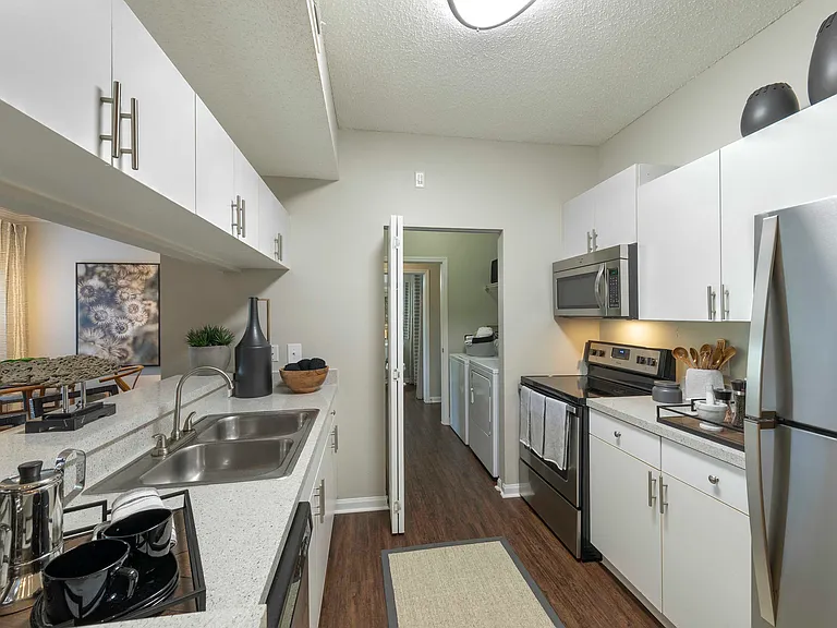 Kitchen with modern appliances and white cabinetry