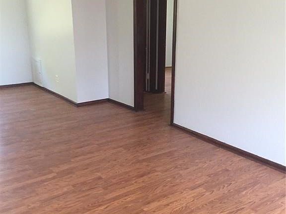 Living room with ceiling fan looking towards hallway