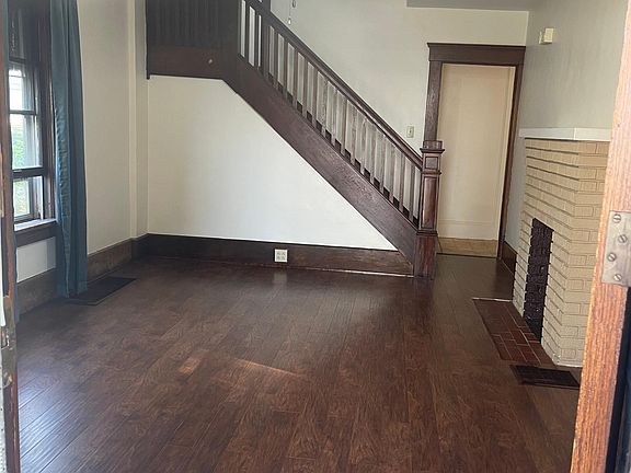 New walnut laminate flooring in living room, continues up the stairs and into upper hallway