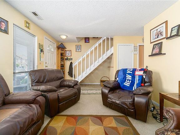 Living room accommodates plenty of furniture.