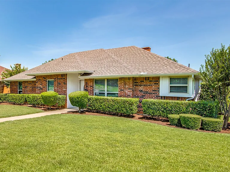 Brick exterior with a gabled roof and white trim