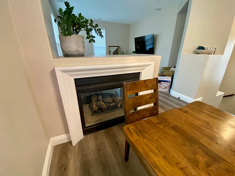 There is a gas fireplace between the dining room and living room.