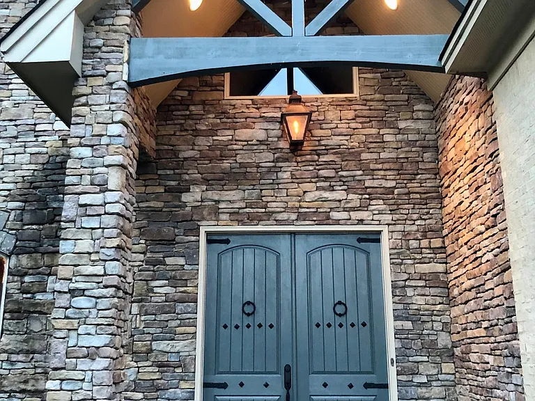 Double door entry, with welcoming gas lamp