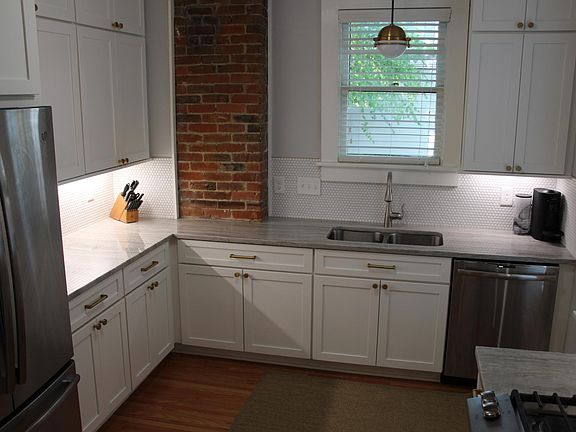 Kitchen with Restoration Hardware hardware, quartzite counters, and new frige, dishwasher, and stove. Pennyround backsplash.