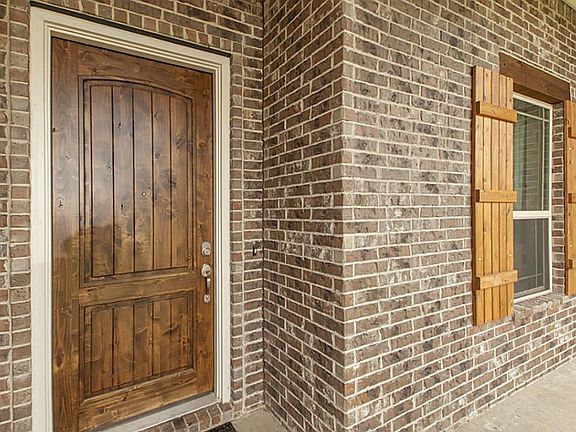 Sturdy solid wood front door with keyless entry.