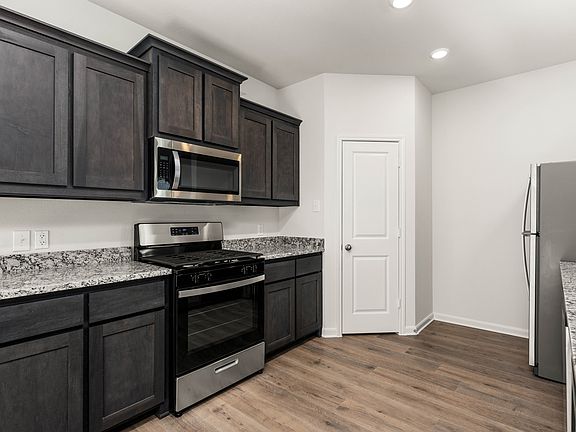 The kitchen of the Reed has beautiful wood cabinetry.